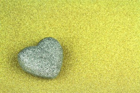 Shiny  golden  glitter paper and heart shape texture background.の写真素材
