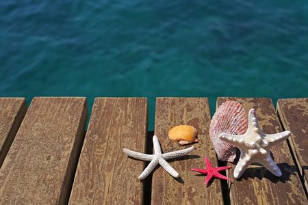 Starfishes and sea shells on wooden beach pier. Summer  Vacation concept.の写真素材