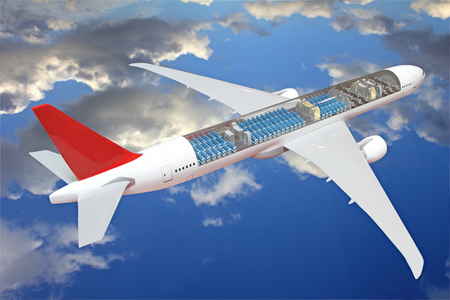 The airplane is flying in the sky and can be seen inside passenger seats