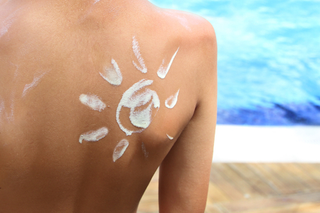 Sunscreen lotion over tan skin, sun protection and vacation concept image.