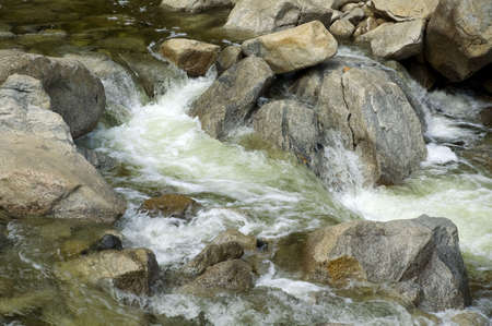 Water gushing over rocks in Yosemite National Park, California.