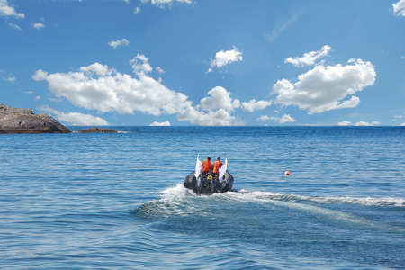 boat with a motor sails to the  sea