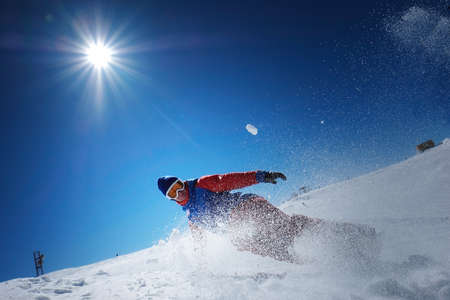 male athlete snowboarder falls on snow. snow is scattered and different sides