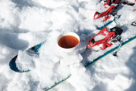 cup of tea in the snow and ski.の写真素材