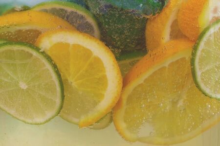 Gas bubbles in the carbonated beverage. Lemonade cocktail. Gases, carbon dioxide. Citrus cocktail...