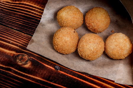 balls of mashed potatoes are lying on paper. Close-up.