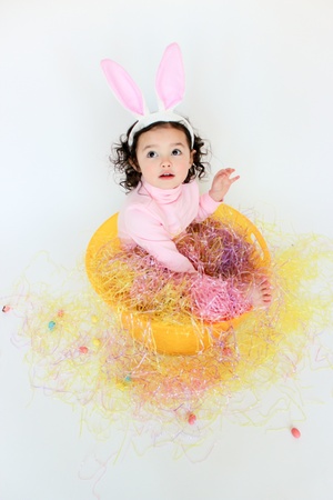 Adorable toddler girl wearing bunny earsの写真素材