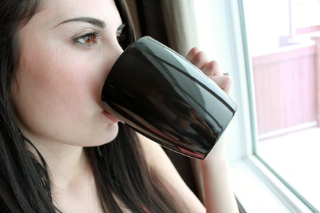 Woman drinking coffee in the morningの写真素材