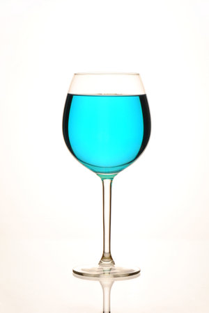 Blue wine in a glass on a white background. isolated.の写真素材
