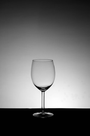Empty wine glass on a black and white background. Copy space.の写真素材