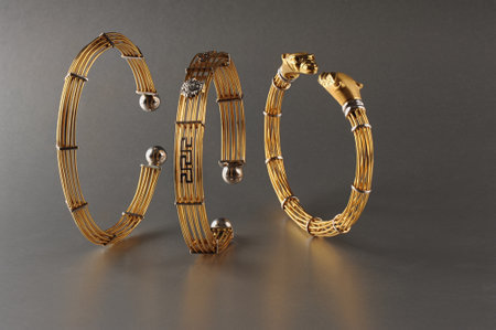 Golden bracelet for men on a gray background.