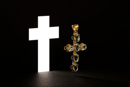 Silhouette of a Christian cross and crystal on a black backgroundの写真素材