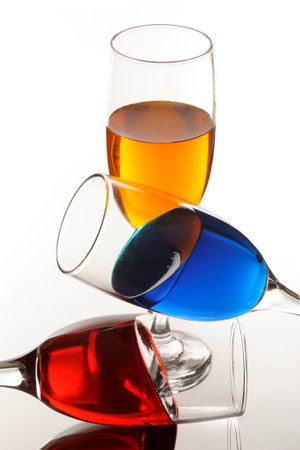 three colorful glasses of wine on a white background close-up.の写真素材