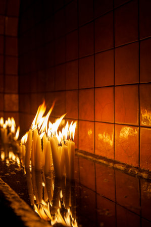 Burning candles in the church. Shallow depth of field.の写真素材