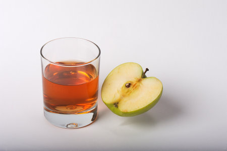 Glass of apple juice and apple on a white background. isolatedの写真素材