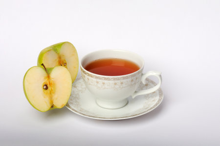 A cup of tea and apple on a white background. isolatedの写真素材