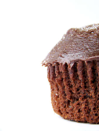 Detailed image of an iced chocolate cupcake, set to the right of the image.  Space remains on left for text or other material.  Whtie background, vertical orientation.の写真素材
