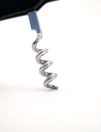 Detailed image of a metal corkscrew with black handle, entering the frame from the top.  Vertical orientation.の写真素材