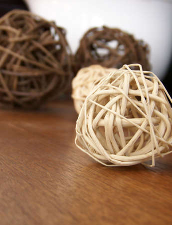 Image of vine decorations on a wooden surface, with white bowl in the background.  Vertical orientation.の写真素材