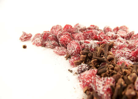 Image of dried cranberries mixed with cloves and white granulated sugar.の写真素材
