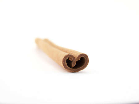 Horizontal image of a single cinnamon stick shaped like a heart.の写真素材