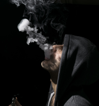 Isolated man doing a jellyfish trick of vaping and electronic cigarette.