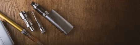 vaping devices or electronic cigarette on a wooden background
