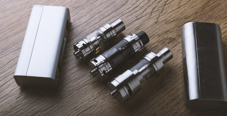 vaping devices or electronic cigarette on a wooden background