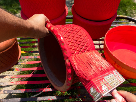 Painting flower pot with bush in a gardenの写真素材