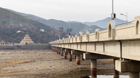 long concrete bridge on a riverの写真素材