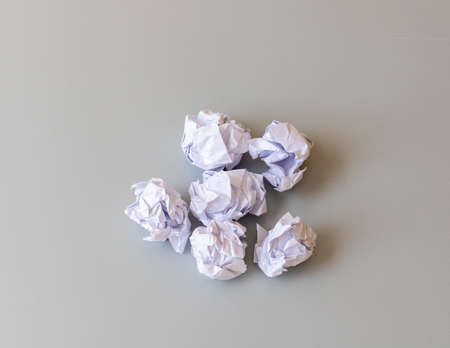 Crumpled paper balls flat lay on a tableの写真素材