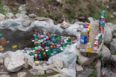 KUMRAT VALLEY, KPK, Pakistan - June, 11, 2022: Carbonated drinks and juices are chilling in natural cold water in kumrat valley, Pakistanのeditorial素材