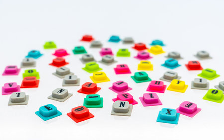 Alphabet letters scattered randomly on white background with selective focusの写真素材