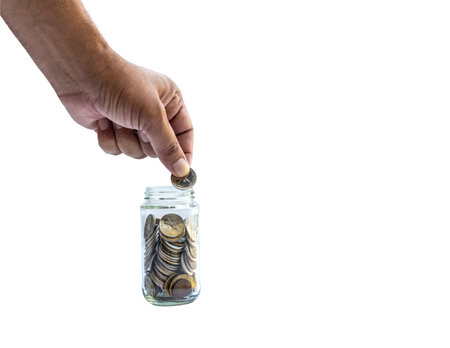 Putting coin in jar. Charity or Donation concept.の写真素材