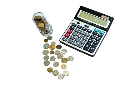 Coins jar with calculator on white isolated backgroundの写真素材