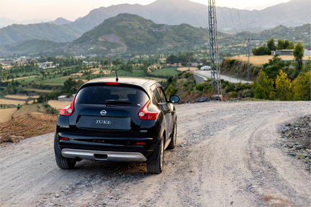 Swat, Pakistan - May 19 2023: Nissan Juke crossover closeup view with a beautiful landscape and mountains backgroundのeditorial素材