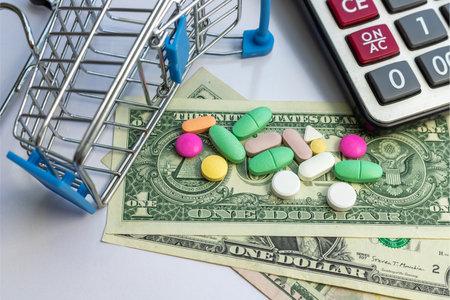 Medical pills and tablets in a mini shopping trolley on white isolated background.の写真素材