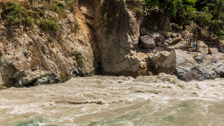 Fresh clear water from flowing along a muddy water in the riverの写真素材