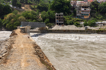 The asphalt road was washed out and destroyed by heavy rain and flood in the swat valley, Pakistanの写真素材