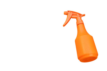 Orange sprayer bottle on white background with copy spaceの写真素材