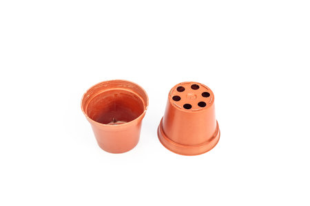 Plastic pots for plants upside down and with drainage holes isolated on a white backgroundの写真素材