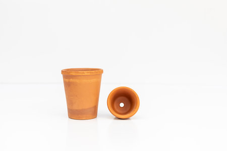 Different sizes of miniature terracotta pots on white isolated backgroundの写真素材