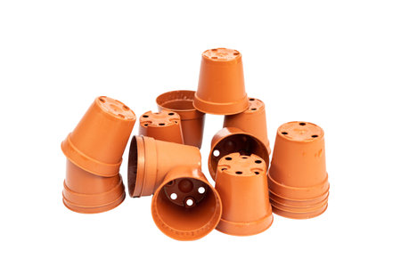 Heap of small plastic pots for plants and seedlings on white isolated backgroundの写真素材