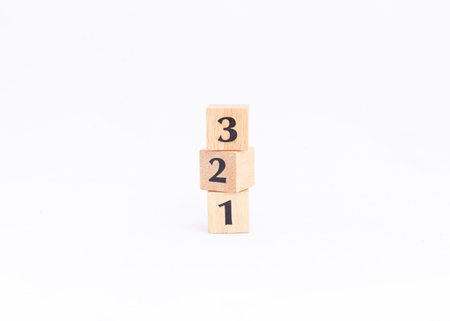 Wooden block numbers tower isolated on white background. Vertical number or ranking concept.の写真素材