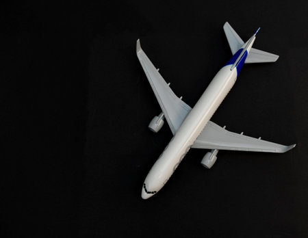 Diecast airplane model on black background high angle view.の写真素材