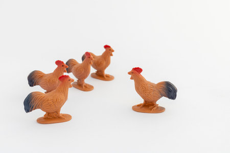 Close-up of a miniature toys five cockerel on a white backgroundの写真素材