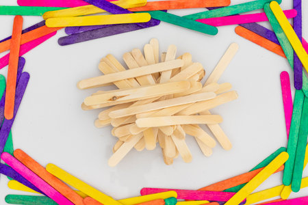 Popsicle wood sticks or Ice cream spatulas with wooden texture or with a colorful sticks frame isolated on white backgroundの写真素材