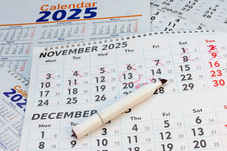 November 2025 calendar with pen and highlighted datesの写真素材