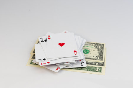 Playing cards on United State of America dollar bills. Gambling and money concept.の写真素材