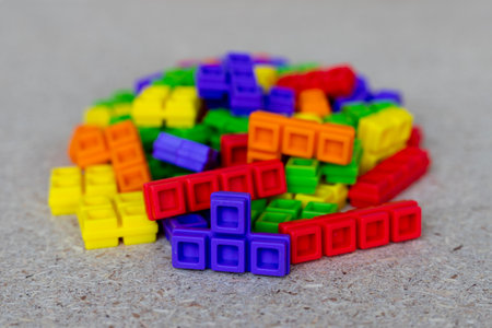 Close-Up of Multicolored Puzzle Blocks Stacked in Pile. Selective Focus with Blurred Background.の写真素材